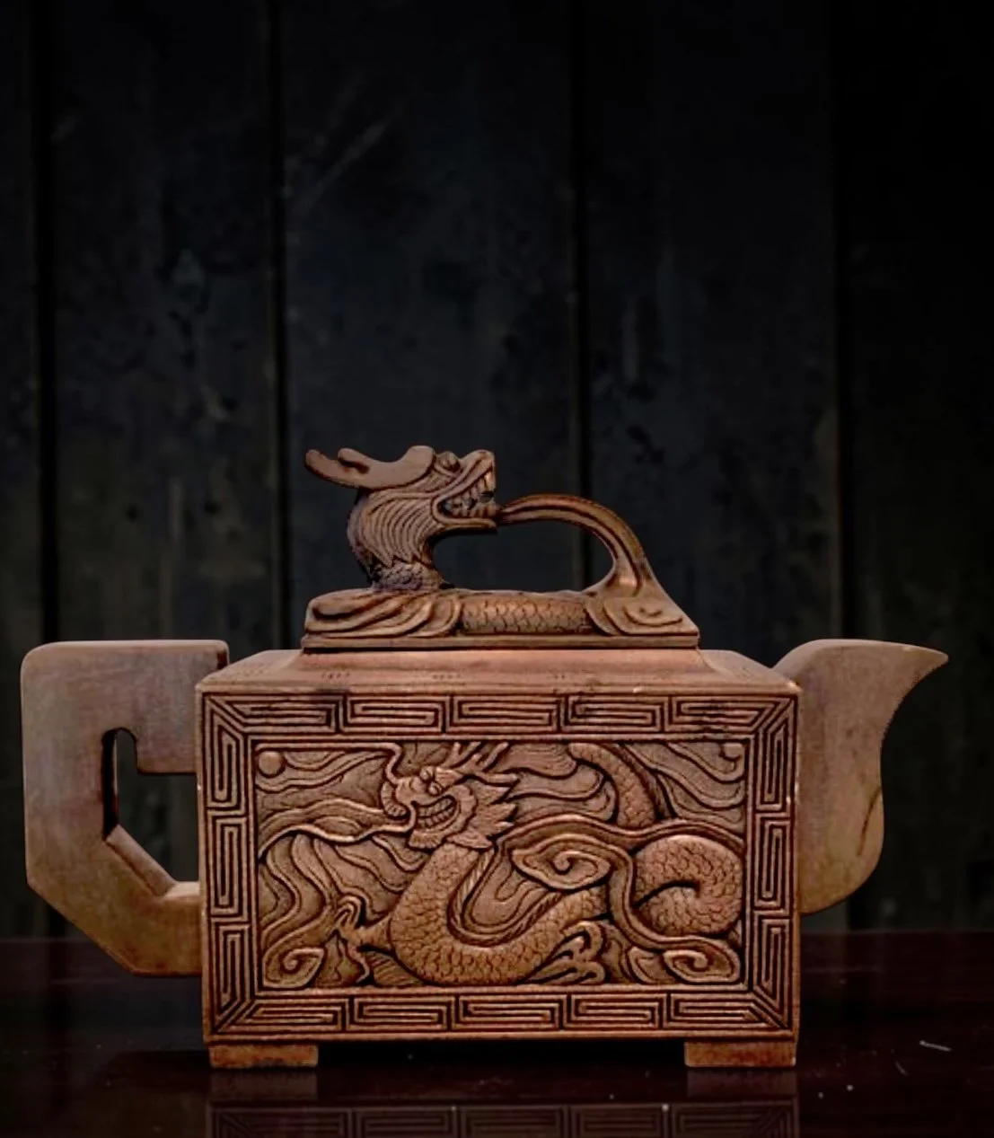 Vintage Yixing-style dragon teapot in the form of an archaic ritual vessel. 
Later 20th c.
Rich sculptural presence with deeply carved dragon relief and warm matte clay surface. 
6 3/4" x 4"
Excellent condition