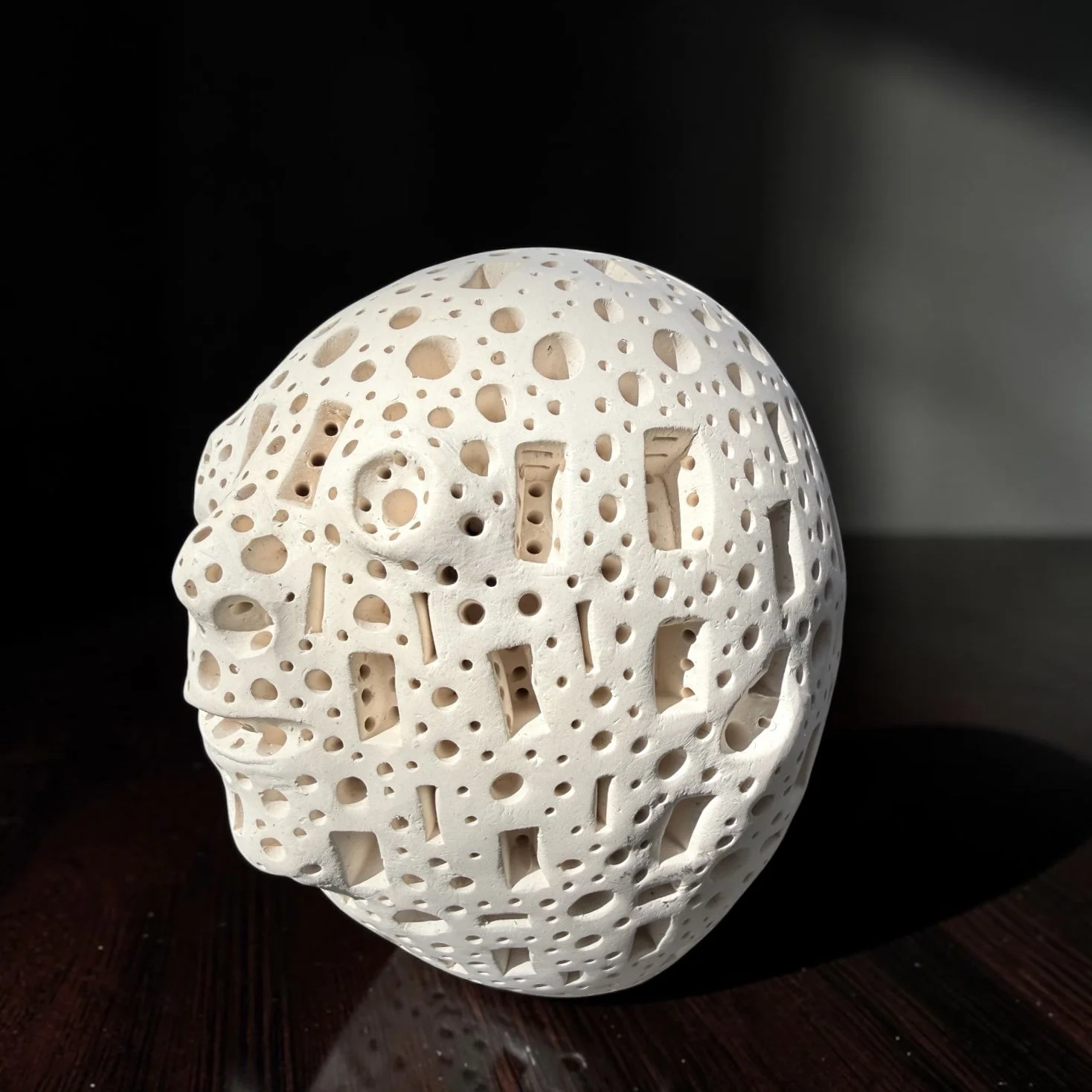 Untitled Perforated Terracotta Head
Alexander Ney (Russian-American, 1939–2023), 
c. 1980s
White/off-white terracotta with extensively pierced geometric surface and stylized facial features
Incised “A. NEY” to underside
approx. 4" H x 5" W.