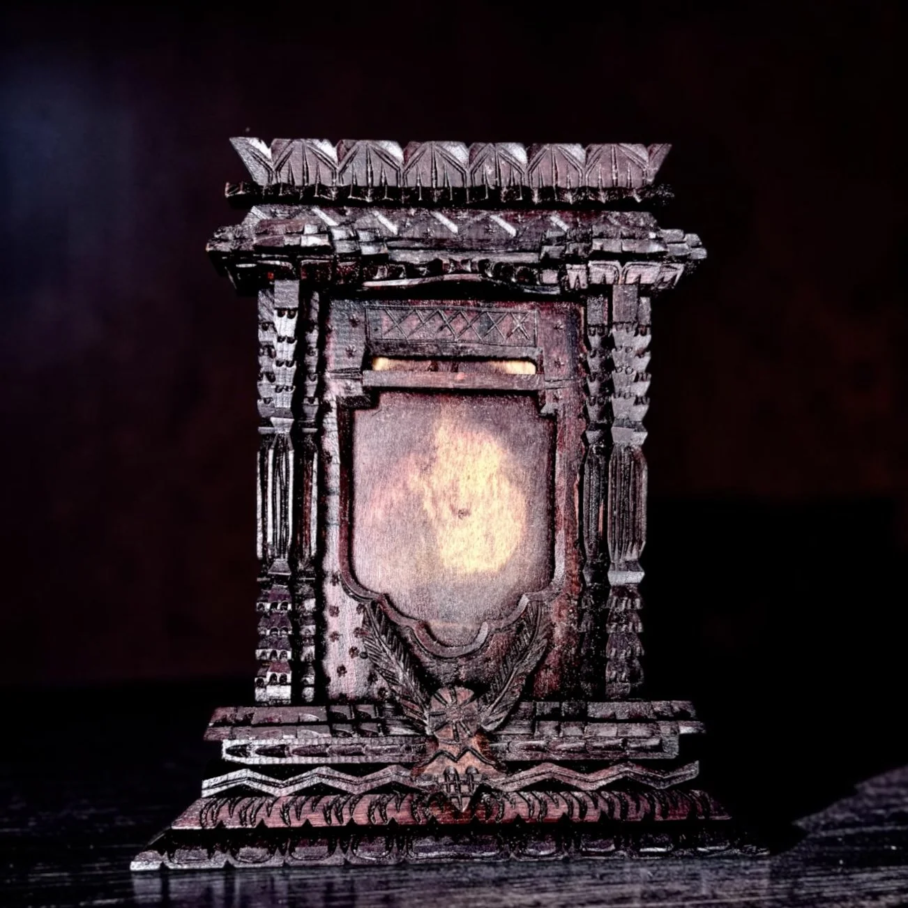 Antique Tramp Art Tabletop Picture Frame with Carved Eagle Motif
Antique tramp art tabletop picture frame, circa 1890–1920, dark-stained wood, elaborate layered and chip-carved construction, central spread-wing eagle motif, architectural column and f
