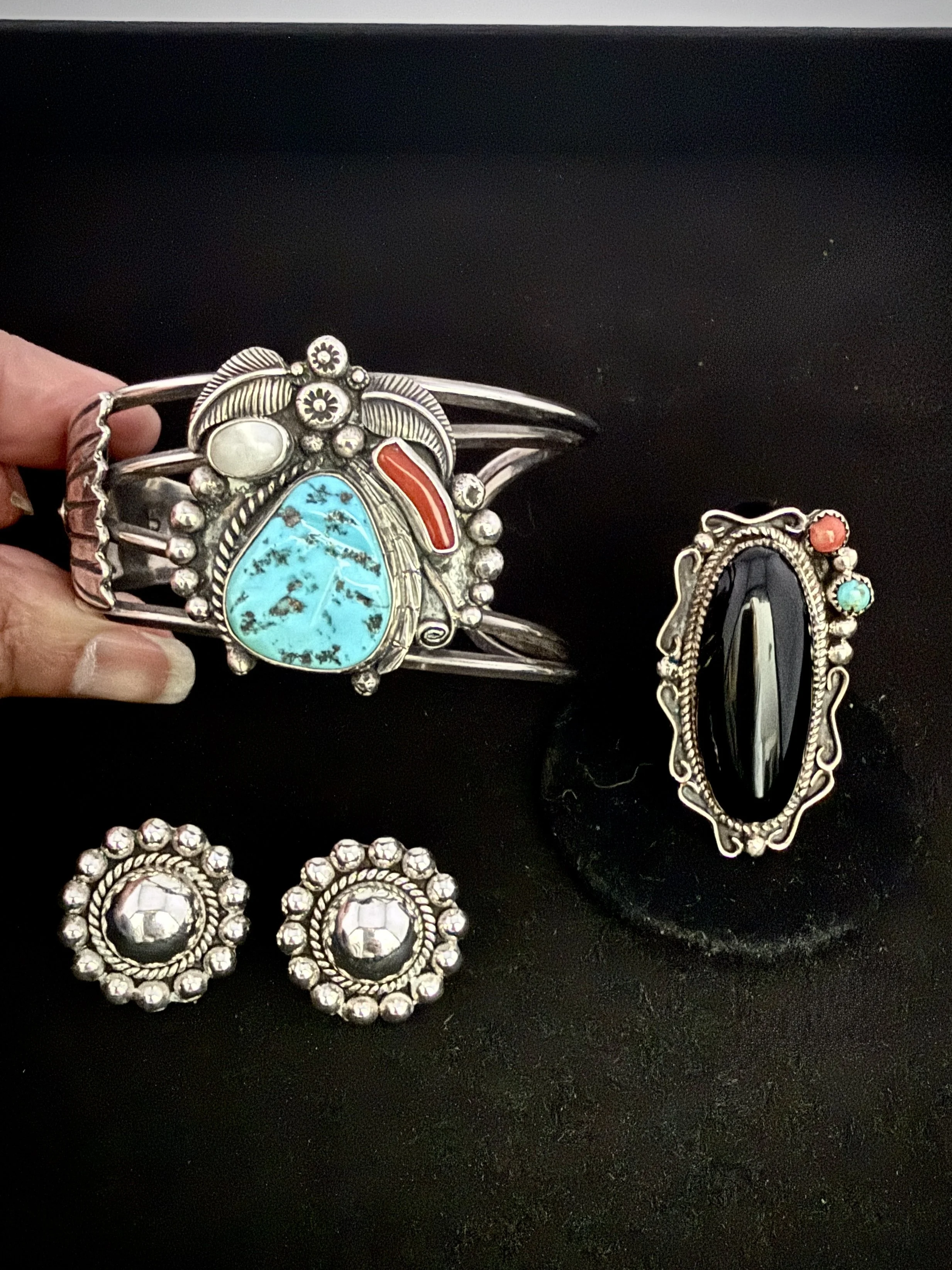 Navajo sterling silver multi-stone cuff, Sleeping Beauty turquoise, coral, mother of pearl, signed JB, c. 1970s — $325
Taxco sterling silver domed concho earrings, registered workshop — $95
Phillip Yazzie, Navajo sterling silver ring, onyx, turquoise