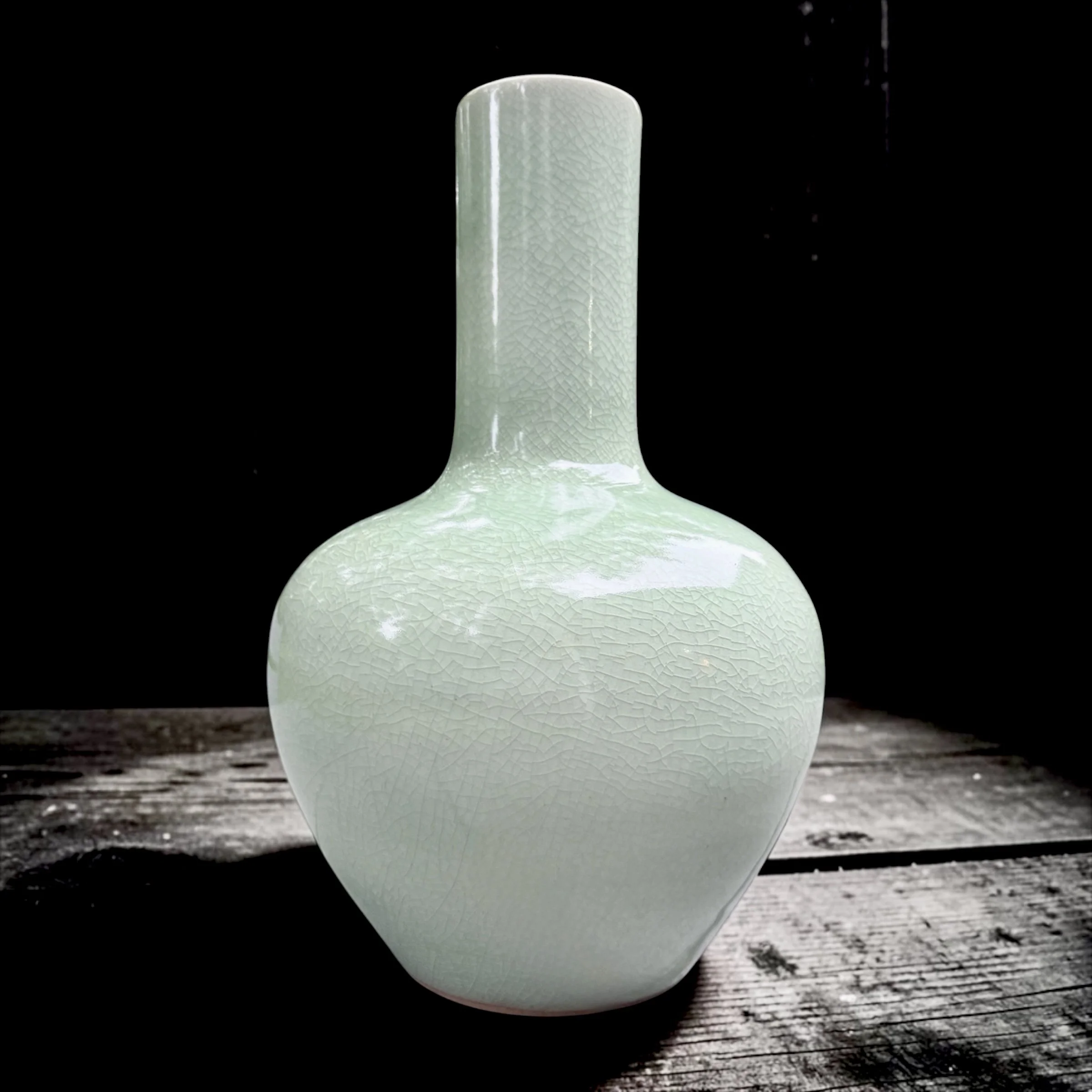 Celadon Tianqiuping (Celestial Sphere Vase), Wheeled-thrown, reduction fired. Sea-green with soft organic surface crazing. 
12"h Excellent condition.