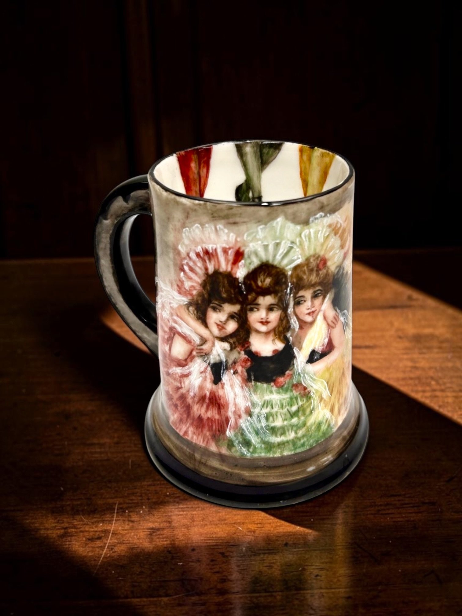 T&V Limoges Hand-Painted Belle Époque Ladies Tankard c.1900
Tressemann & Vogt Limoges porcelain, France, c.1900, hand-painted figural decoration depicting three fashionable Belle Époque women in elaborate hats and dresses, raised white enamel accents