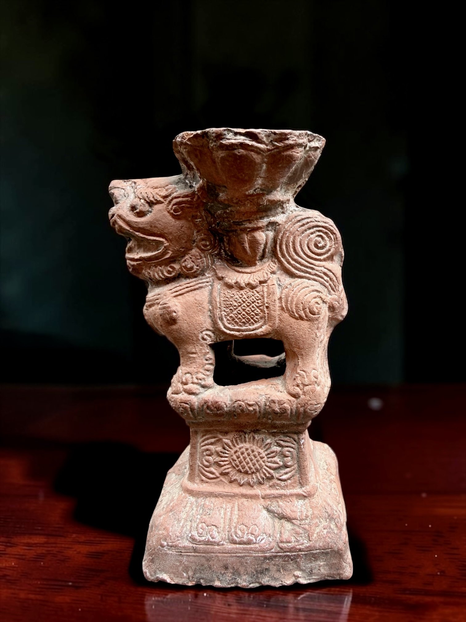 Early - Mid 20th Century Chinese Terracotta Guardian Lion Incense Burner
China, Molded and hand-finished raw terracotta, stylized guardian lion supporting a lotus-form burning bowl, hollow vented construction, incised saddle cloth, floral and cloud-s