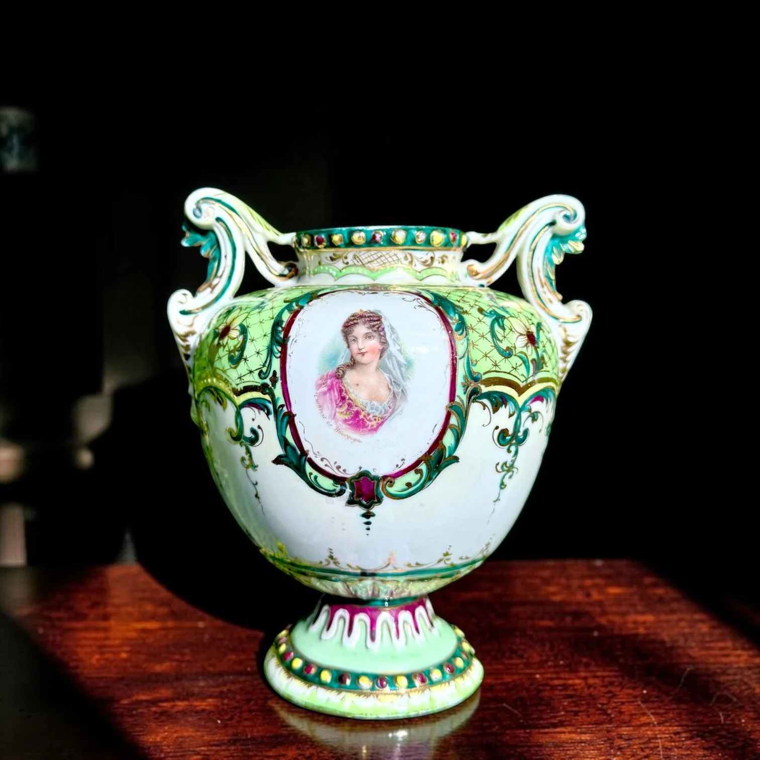 Late 19th-century Austrian/Bohemian porcelain portrait vase, “Duchesse de Bourgogne,” 
c. 1890–1910
Green ground, gilt and raised enamel decoration, floral reserves, pierced rococo handles, unmarked
6.25" H x approx. 5" W