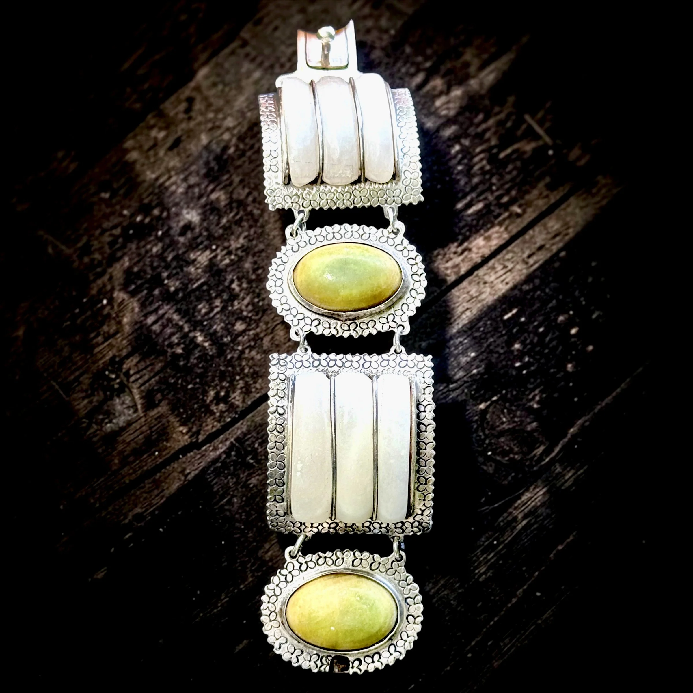 Taxco Sterling Panel Bracelet - c. 19405s-50s - White onyx and serpentine cabochons
Four-link articulated construction with stamp work floral borders - $425