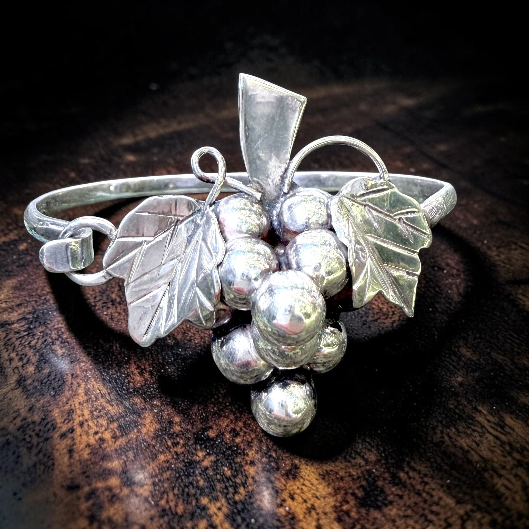 Vintage Taxco Sterling Silver Grape Cluster Bracelet
Dimensional cluster of grapes with hand-formed leaves and curling vine details
Likely mid 20th c.