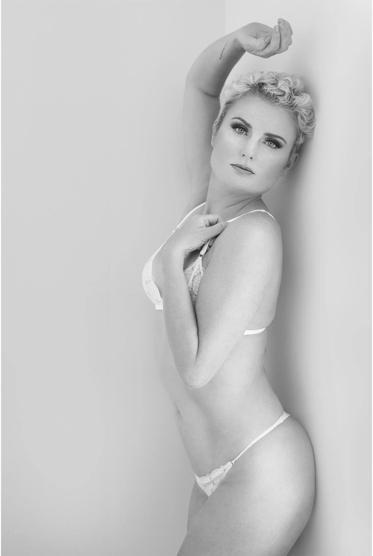 •	Glamour boudoir portrait with soft studio lighting