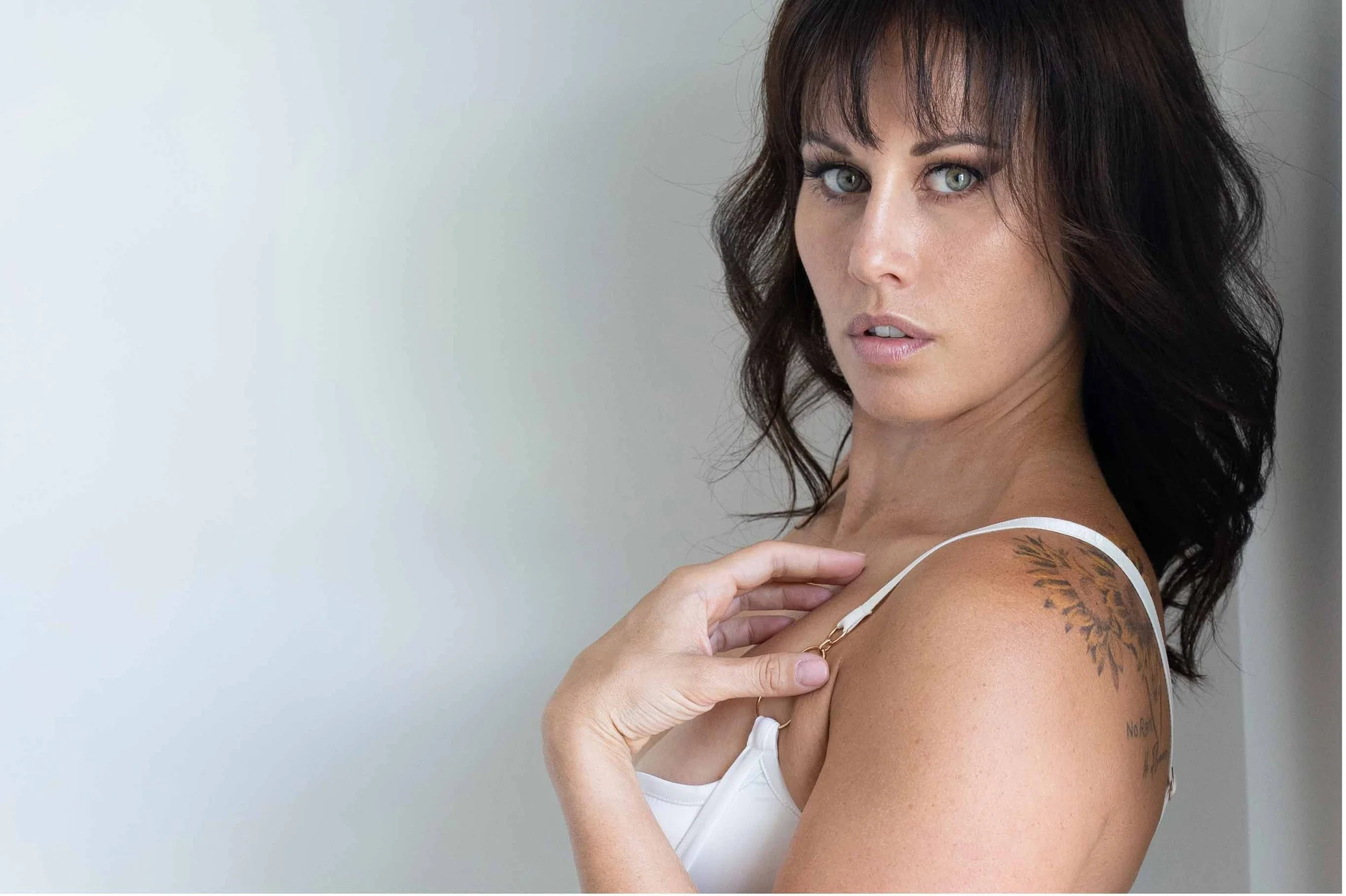 Soft colour boudoir portrait with relaxed eye contact