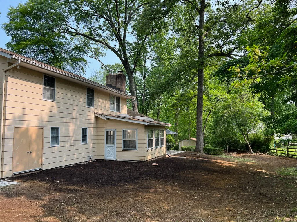 Backyard of a house with fresh soil from basement excavation.