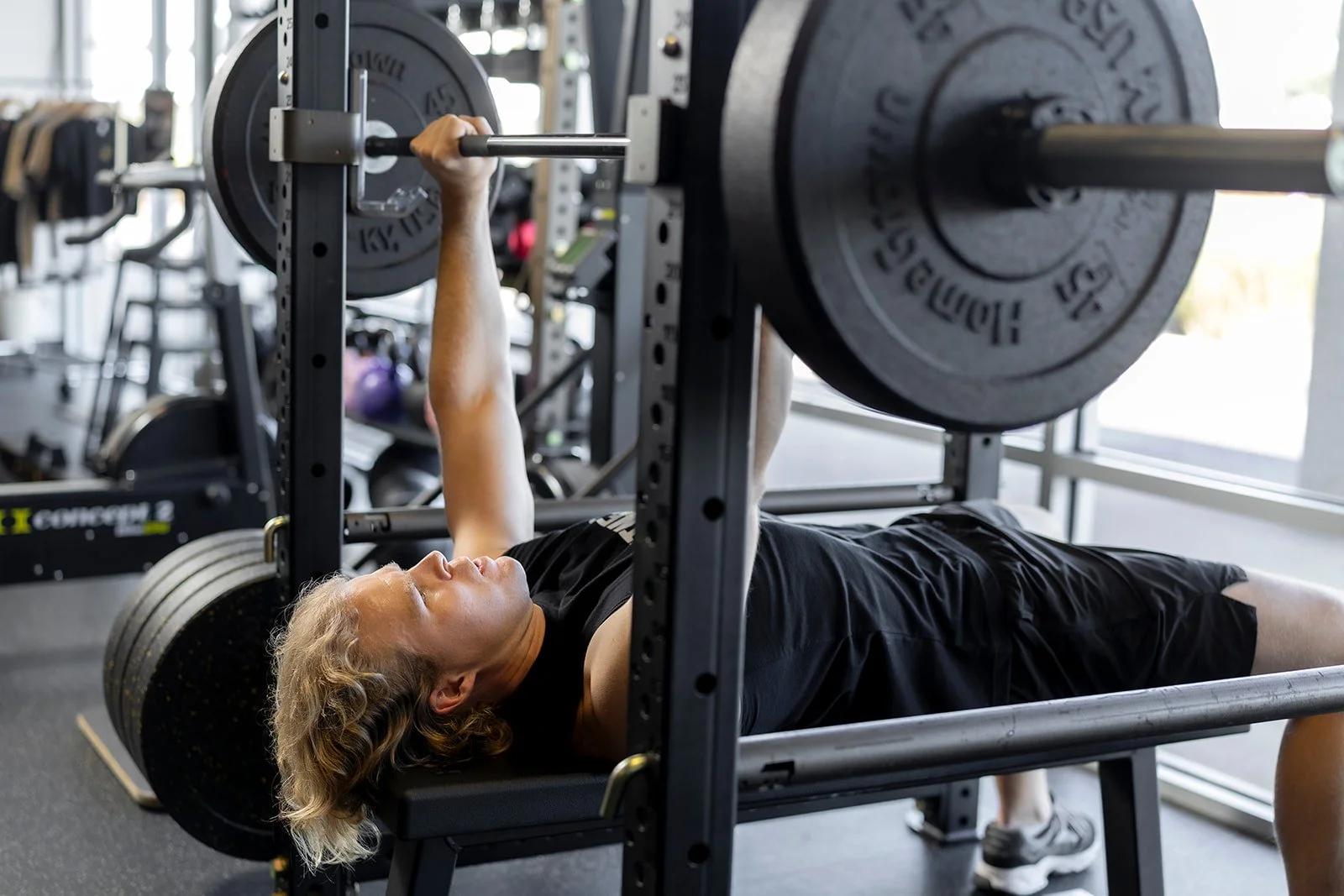 Wes Campbell, personal trainer at Sol Fitness, performing a bench press