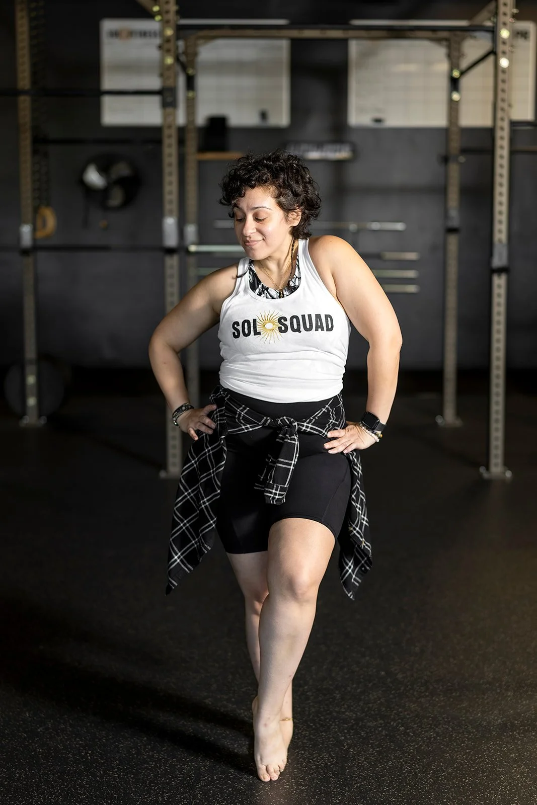Jenée Tonelli, Zumba instructor at Sol Fitness, striking a dance pose in a Sol Squad tank top