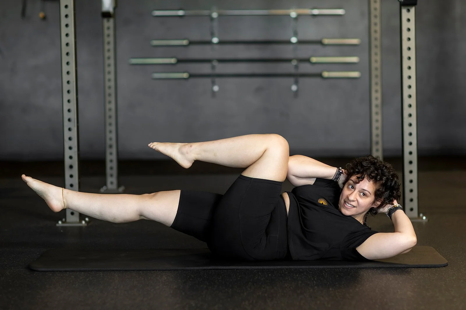 Jenée Tonelli, Mat Pilates instructor at Sol Fitness, demonstrating a Pilates exercise on a mat