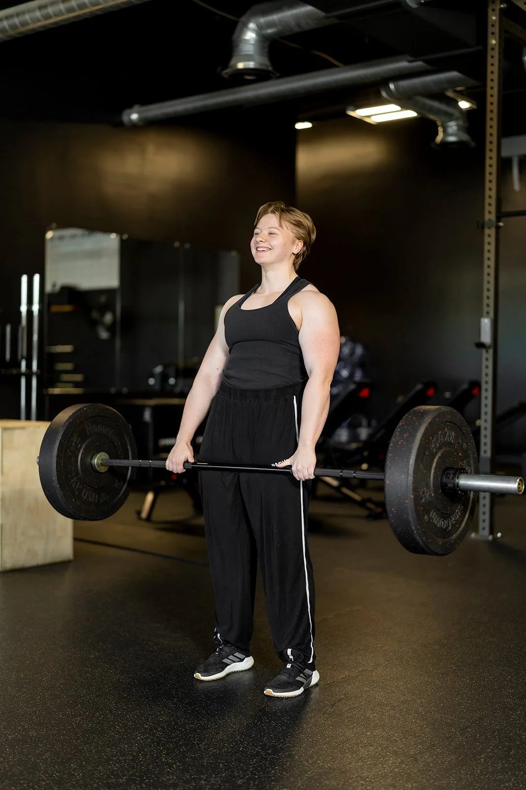 Macy Thacker, personal trainer at Sol Fitness, performing a barbell deadlift