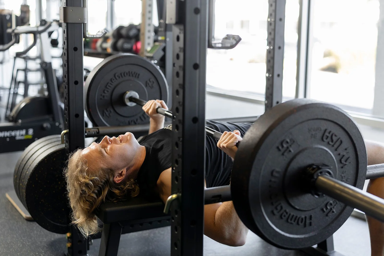 Wes Campbell, personal trainer at Sol Fitness, performing a bench press