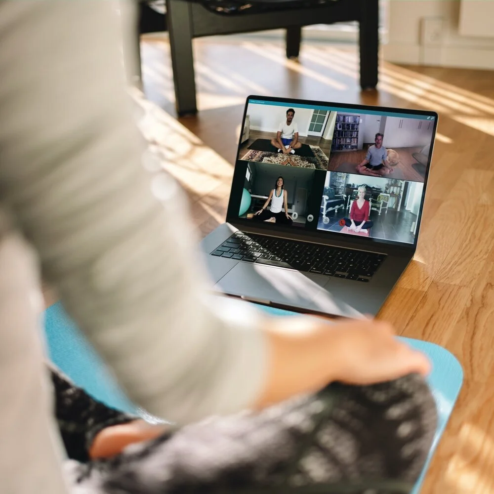 Omg+Office+Yoga+__+Group+of+people+practicing+yoga+with+trainer+via+video+conference.jpg