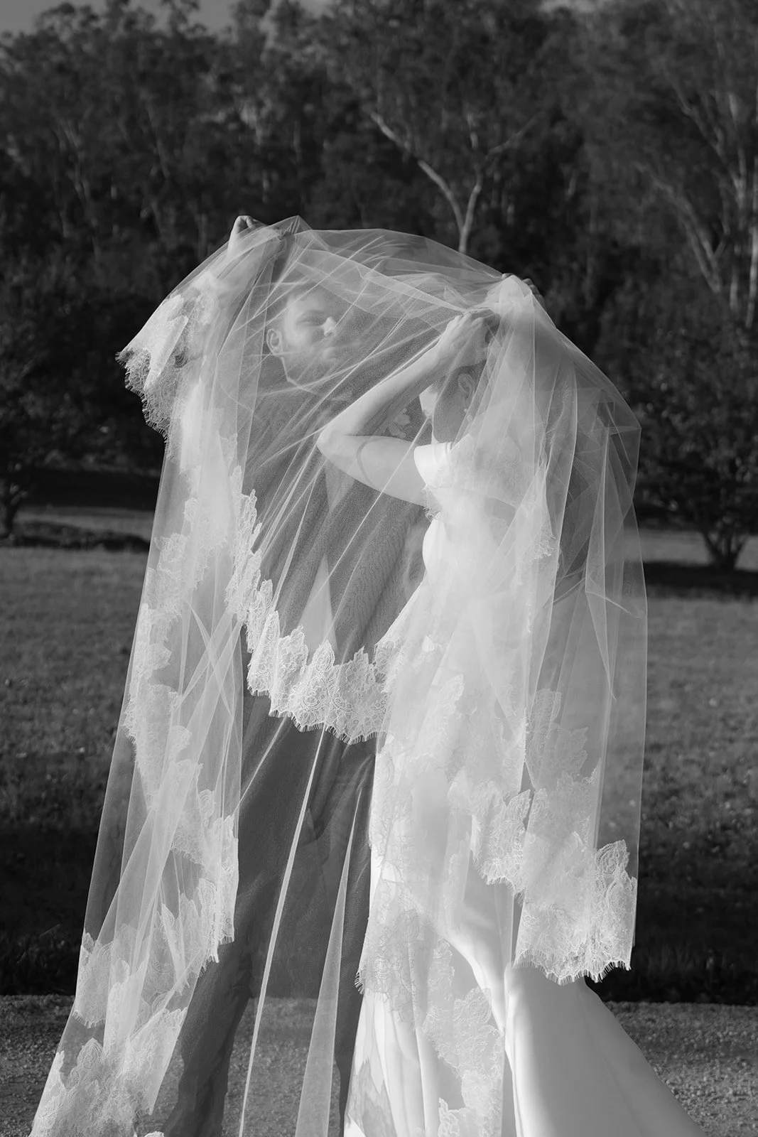 Couple embracing beneath the bride’s veil at Redleaf Wollombi wedding in the Hunter Valley