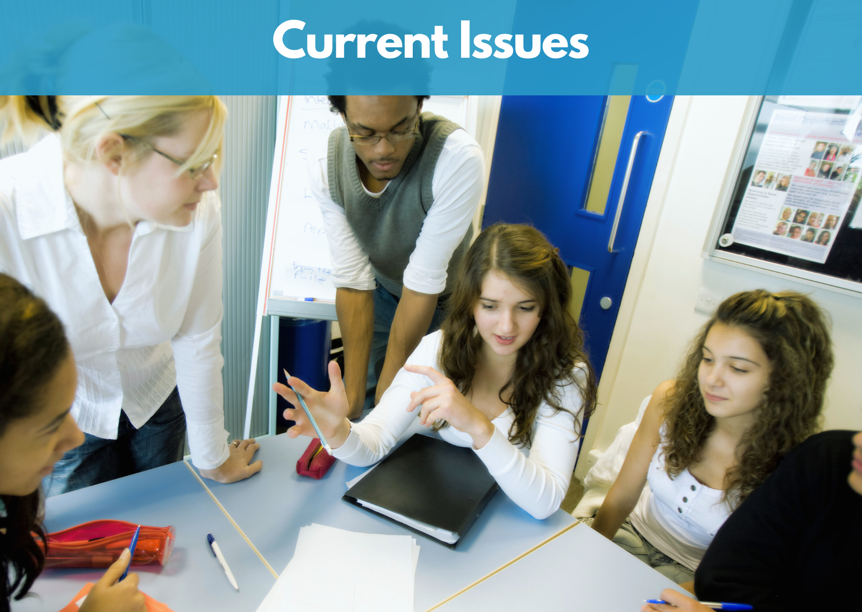 Group of young adults having a discussion around a table with papers and pens.