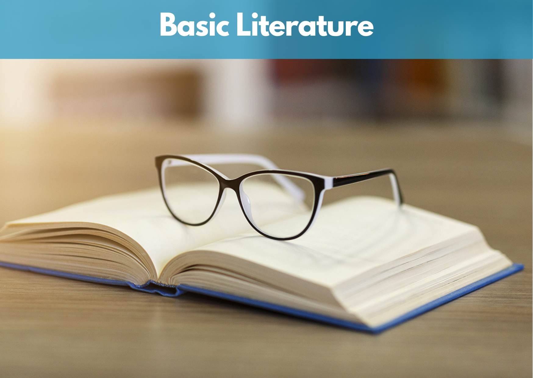 Open book with glasses resting on top, labeled "Basic Literature."