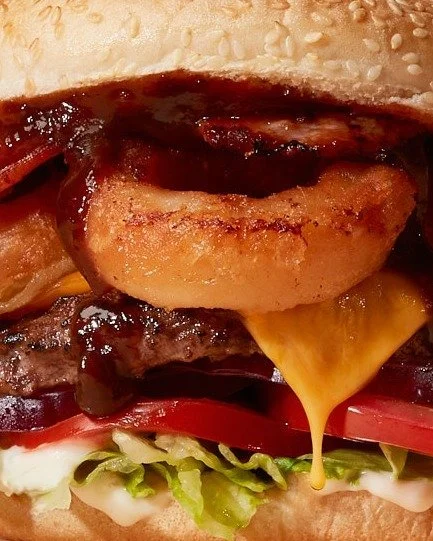 The fully stacked BBQ Beef &amp; Bacon burg. 100% NZ Beef, bacon, onion rings, cheddar, BBQ sauce, mayo, salad, and relish on a sesame seed bun 🤤