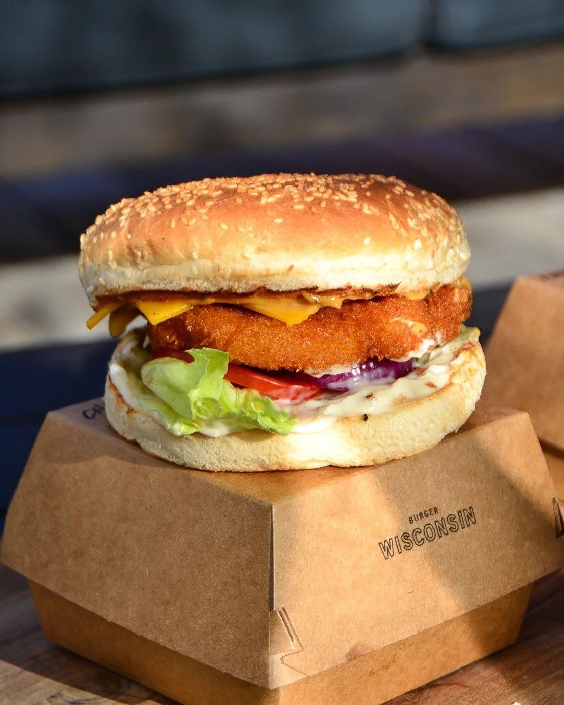 The Big Island: crumbed chicken, bacon, pineapple rings, cheddar, mayo, and salad on a sesame seed bun. 🤤