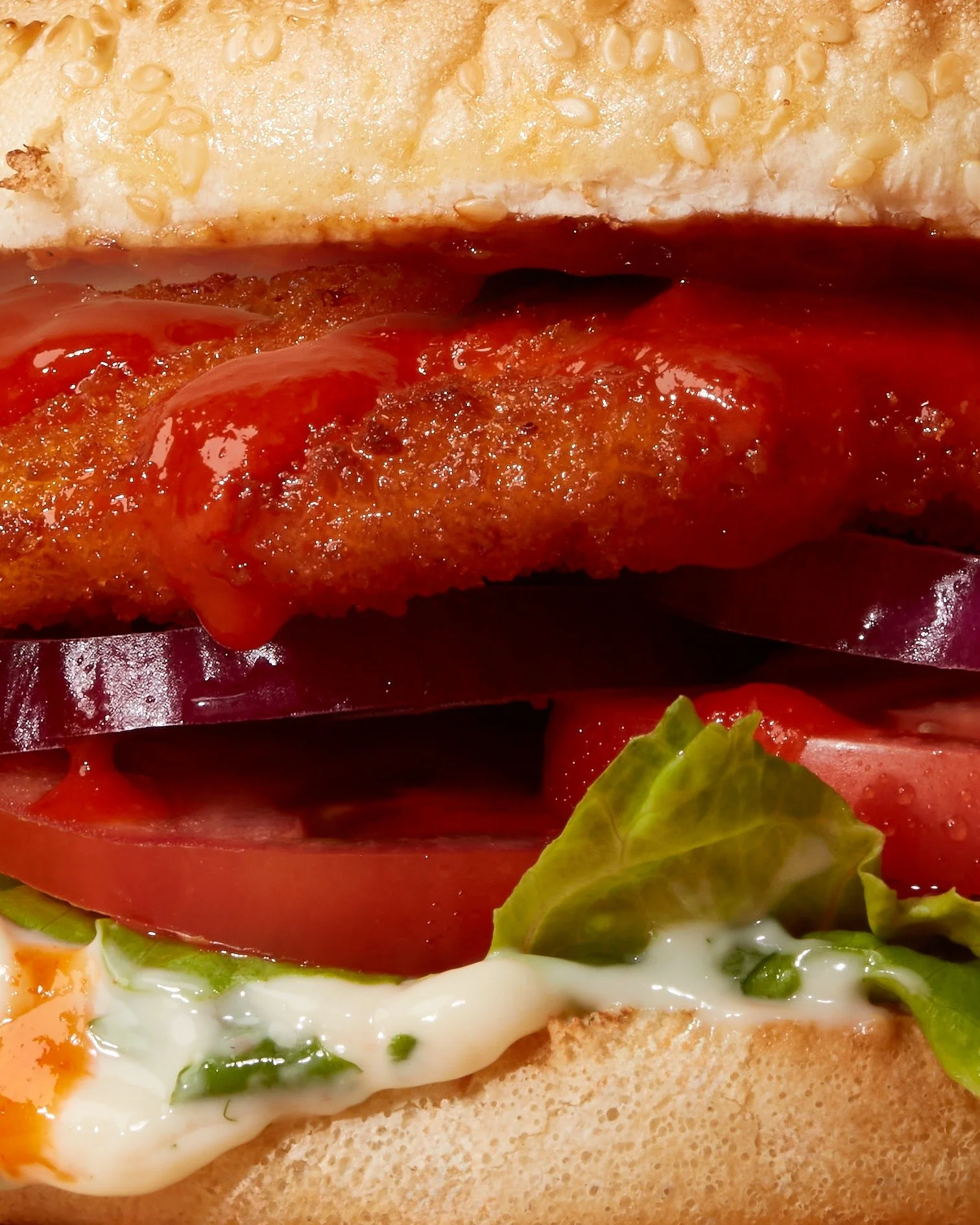 Spice up your life with the Bird on Fire. Crumbed chicken, sriracha sauce, coriander and lime mayo, salad &amp; relish on a sesame seed bun. 🍗 🌶️