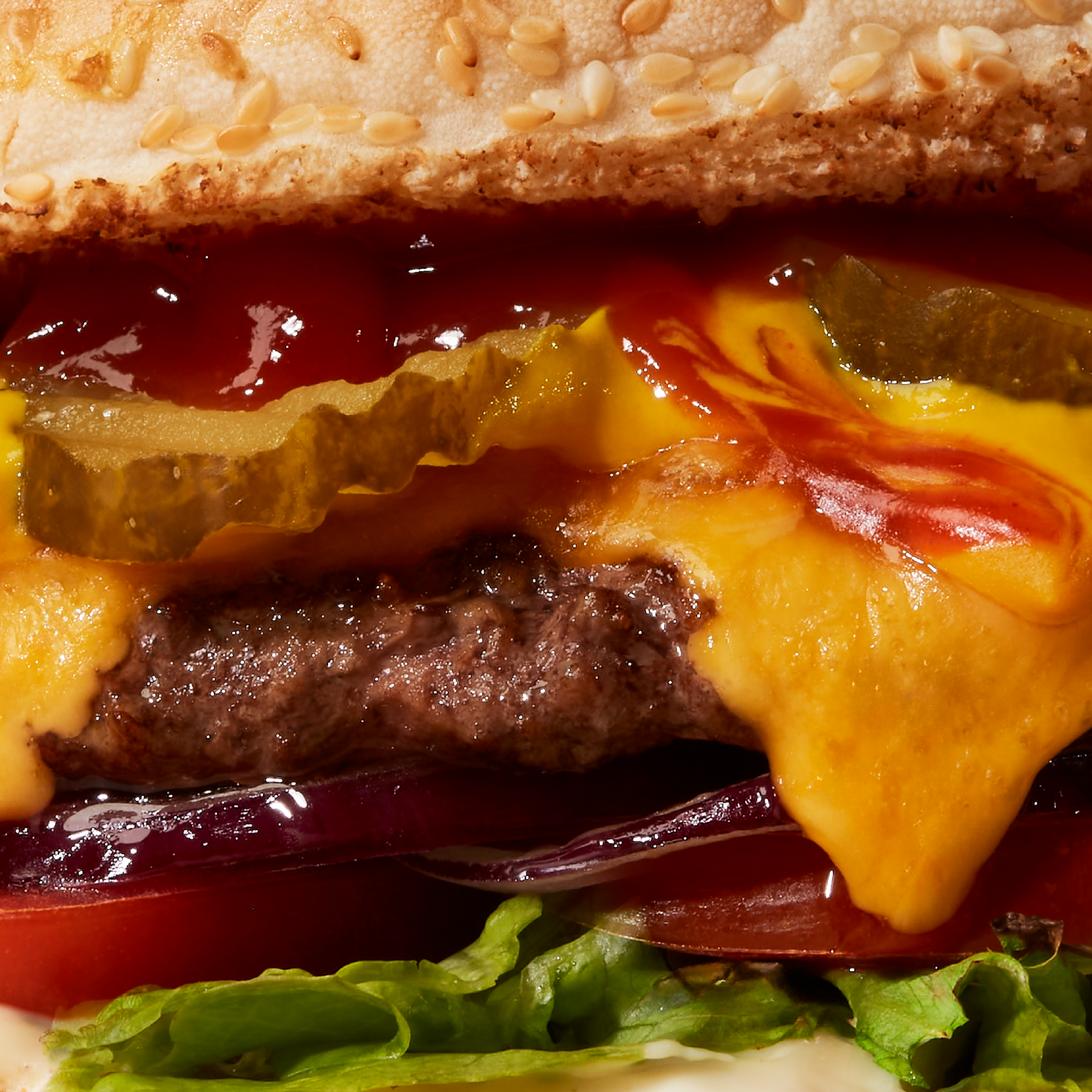 Big burger with dripping cheese and a beef patty.