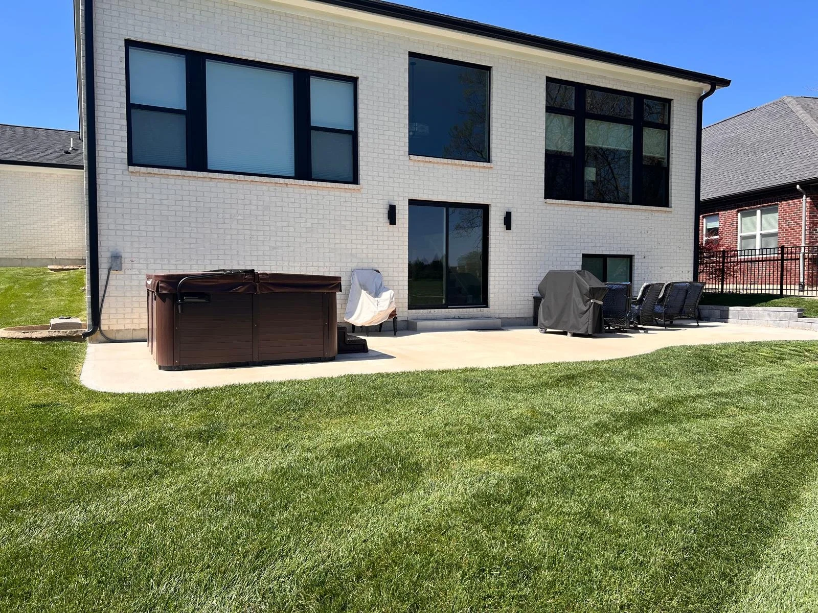 Backyard patio area behind a residential home before installation of a Solara patio cover