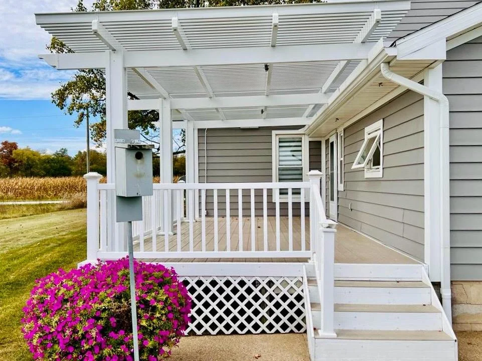 Open pergola patio cover in an Ohio backyard, allowing natural sunlight through the slatted roof while keeping the outdoor space bright and airy.