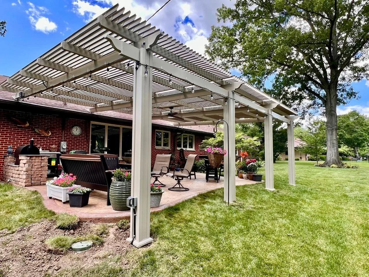 Professionally installed pergola patio cover in an Ohio backyard with integrated lighting and structured aluminum beams.