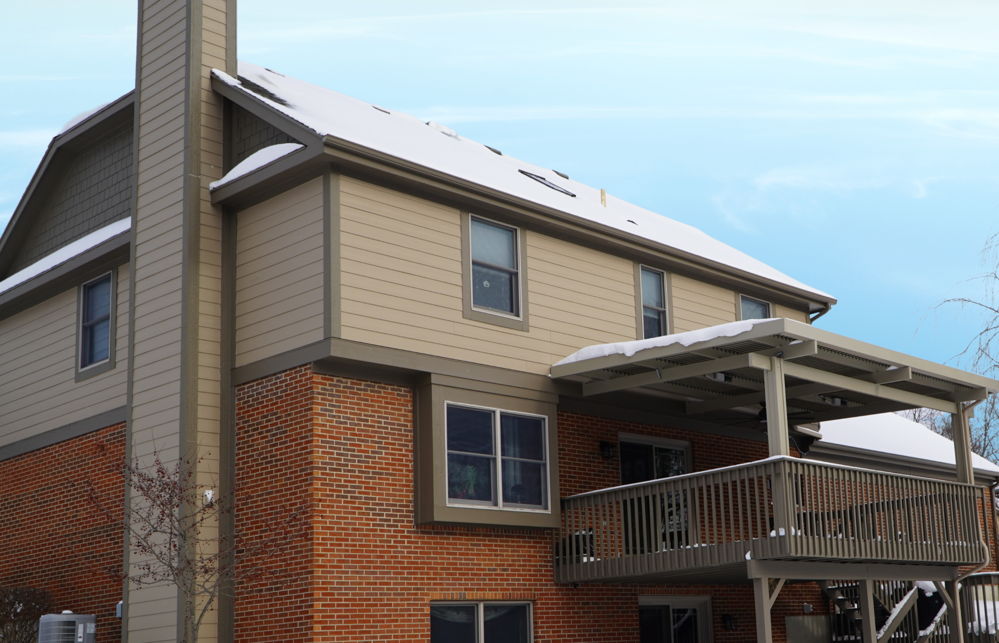 Patio Covers Ohio - A Solara patio cover integrated into an Ohio home, protecting the patio space even after a winter snowstorm.