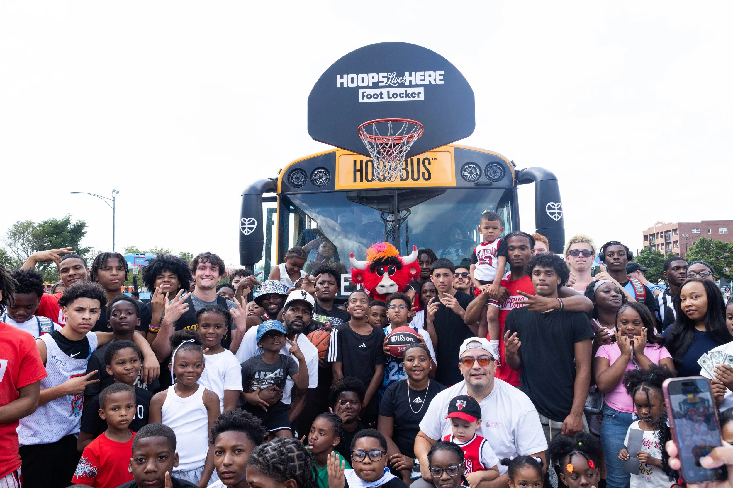  Chicago Bulls fans of all ages pose for a photo with Benny the Bull at the Hoopbus. 