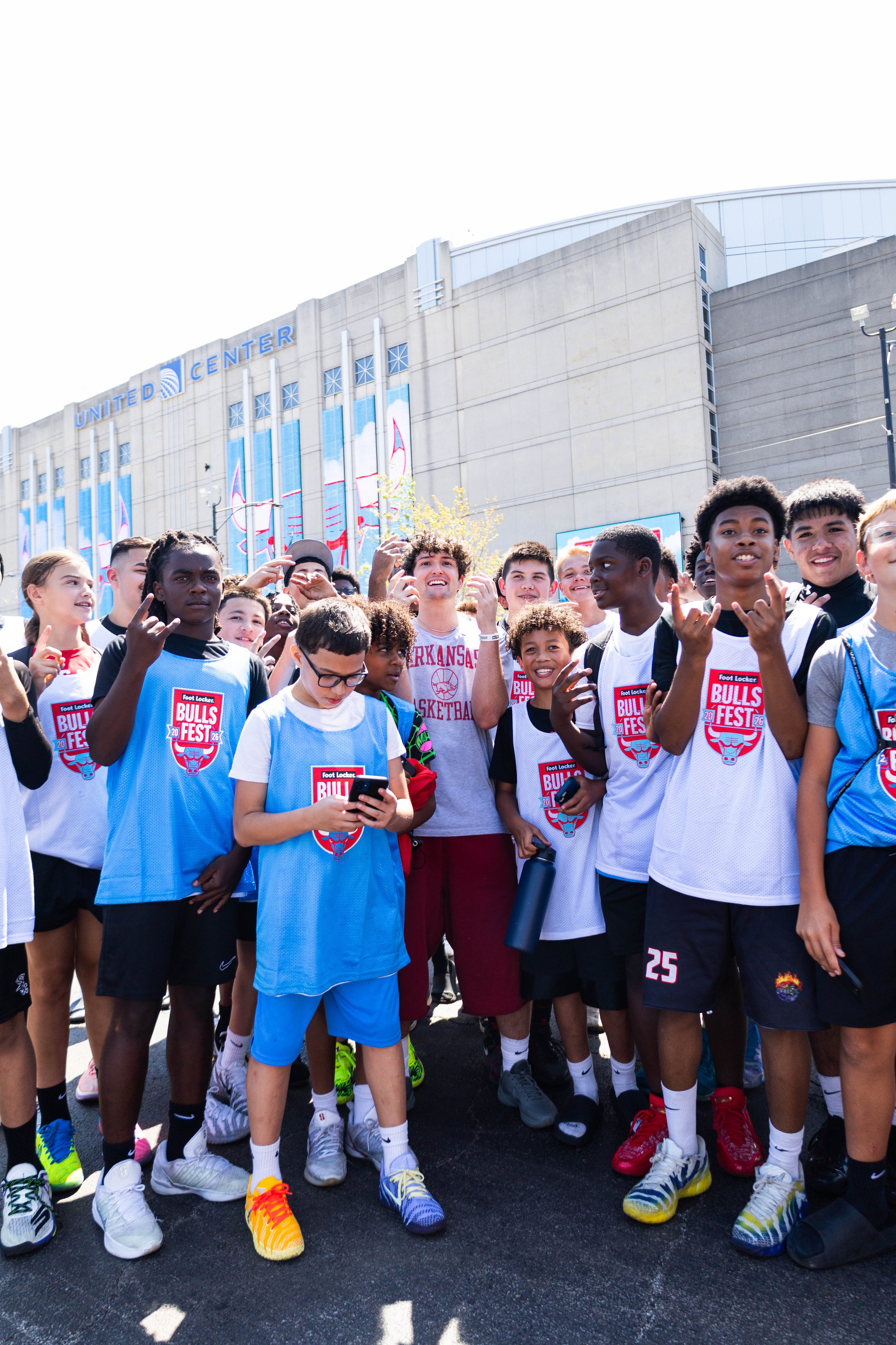  Youth athletes posing for a photo outside United Center. 