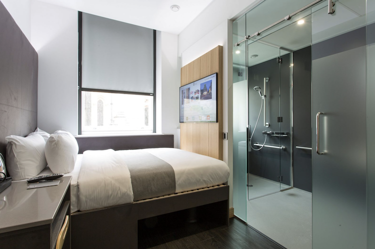boutique hotel z hotels London window, and a bathroom with glass doors and a shower.