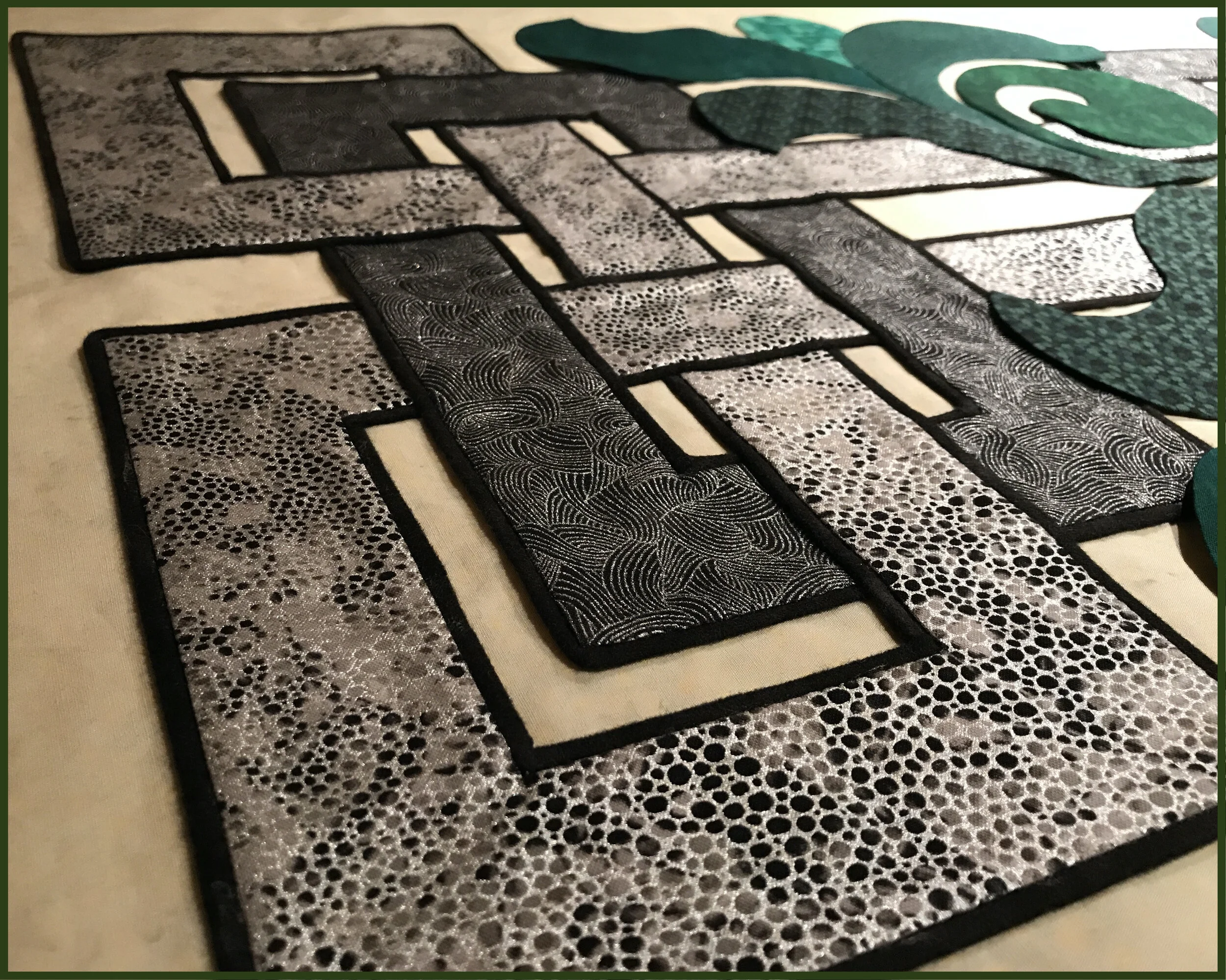 Details of the turned-edge machine applique with piping - the blind hem stitch in the ditch between the applique and piping secures both the applique and the piping