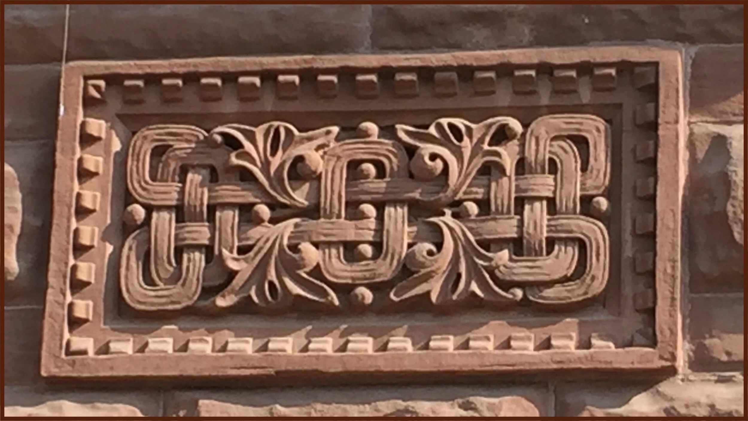 The stone wall with balls and leaves (?) that inspired the machine applique