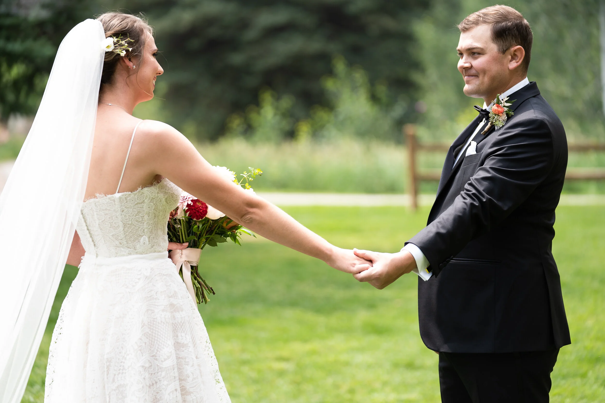 Bride and groom holding hands outdoors in Vail, CO