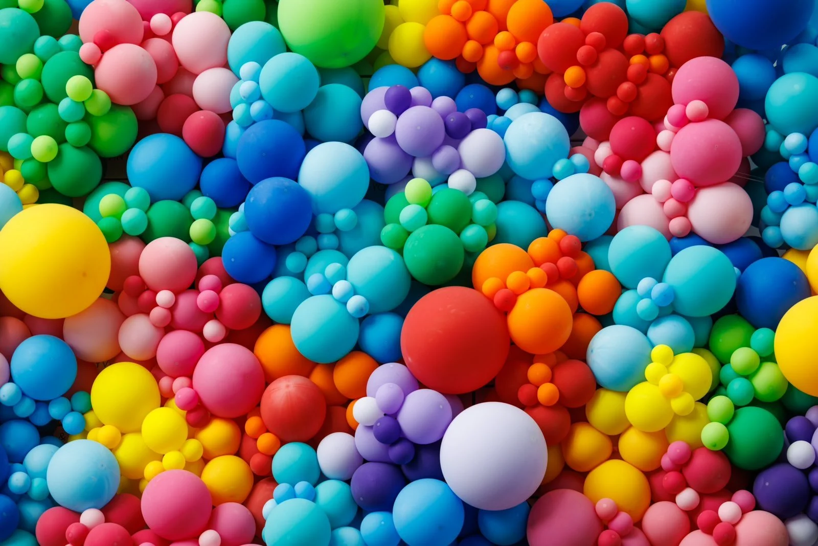 ibrant rainbow balloon cluster celebrating Pride, bursting with an array of incredibly bright colors, radiating joy and inclusivity.