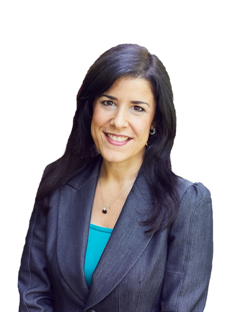 A woman with long dark hair smiling, wearing a gray business suit and a turquoise top, against a plain background.