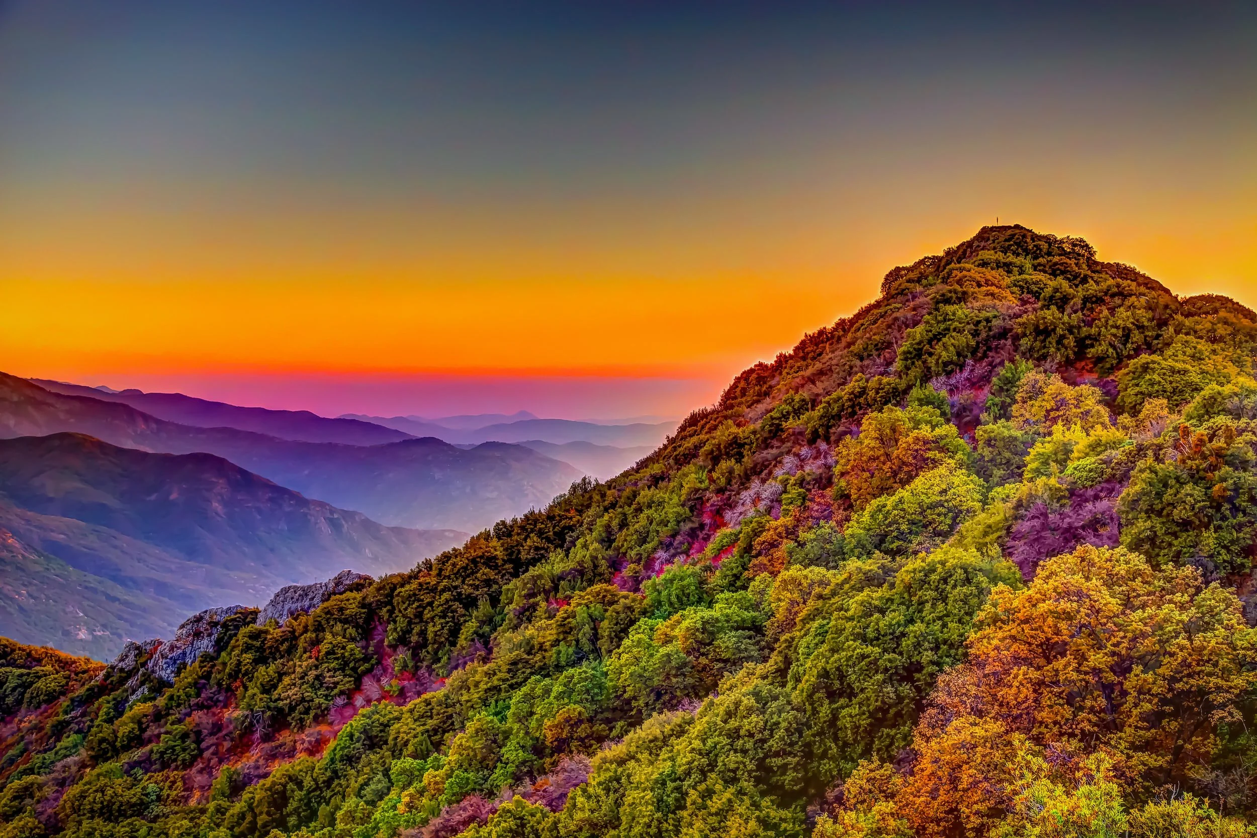 Colorful mountain landscape during sunset with layers of mountains and a sky transitioning from orange to deep blue. (Tantric, relational, relationship, natural, organic, aphrodisiac, supplements)