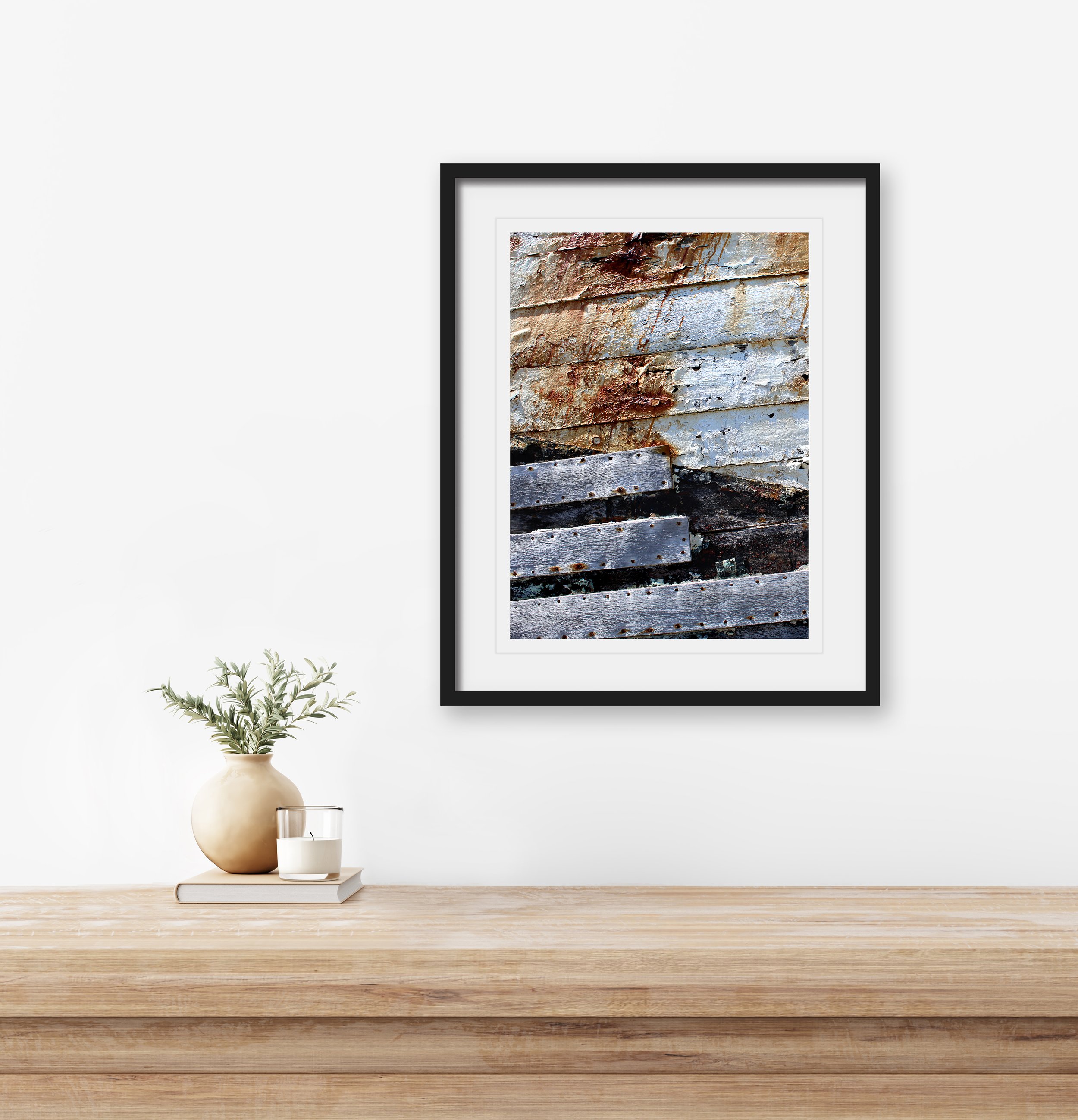 Traditional interior wall mockup with green twigs in vase and candle standing on light brown wooden table on empty white background. 3D rendering, illustration