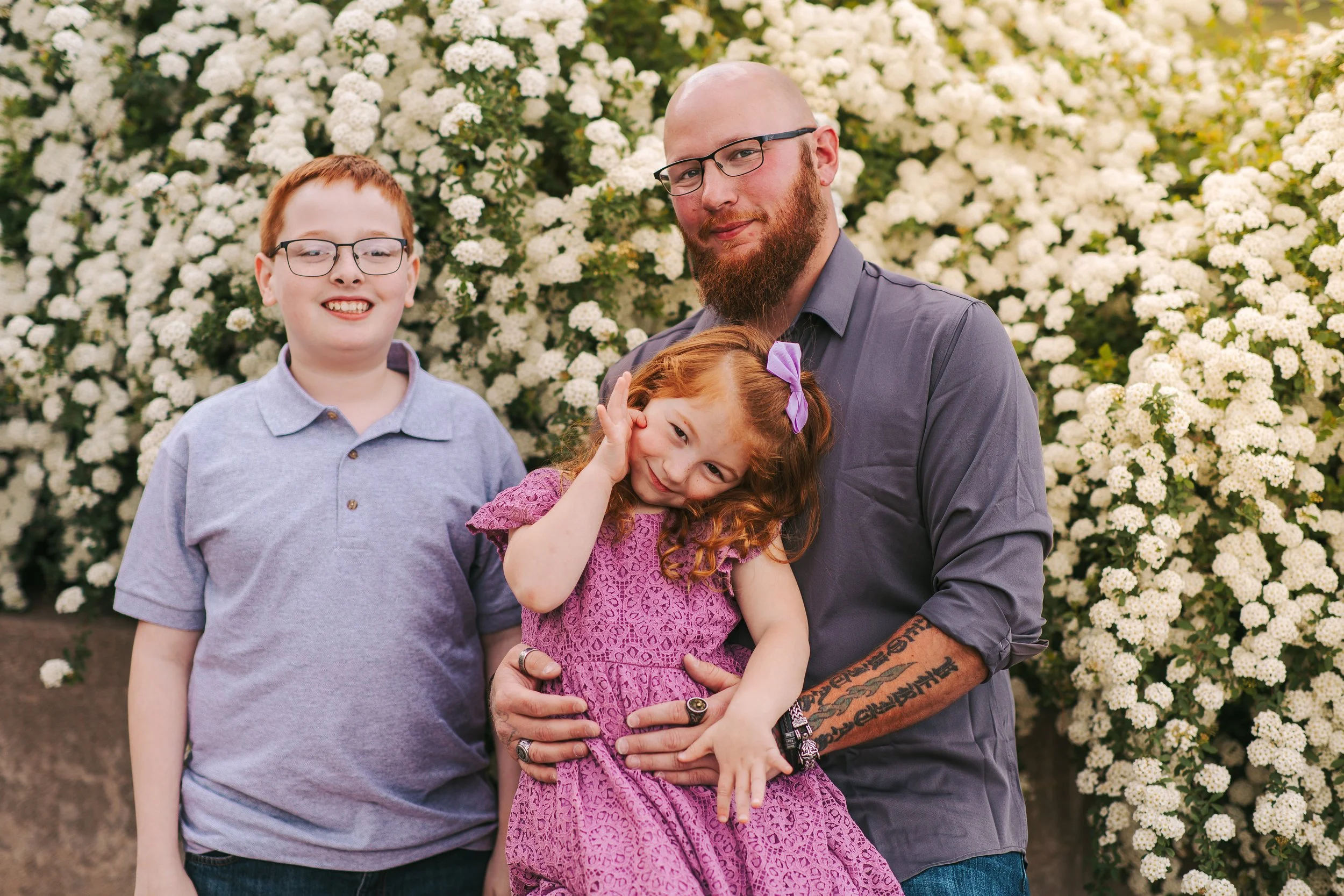 Dad playing with kids and smiling during a stress-free family photo session near Kearney, Nebraska