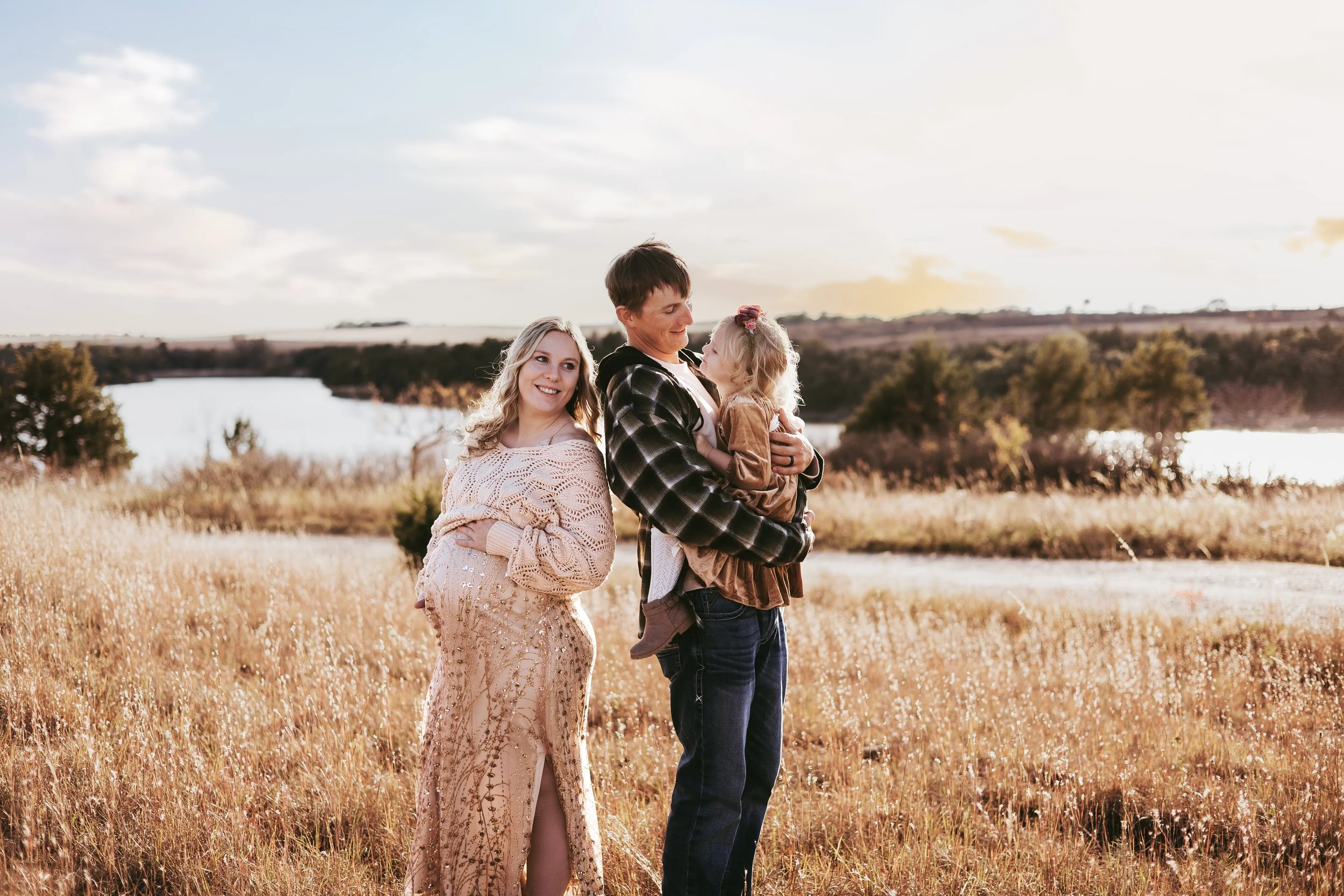 Candid family laughing during a relaxed outdoor family photo session in central Nebraska