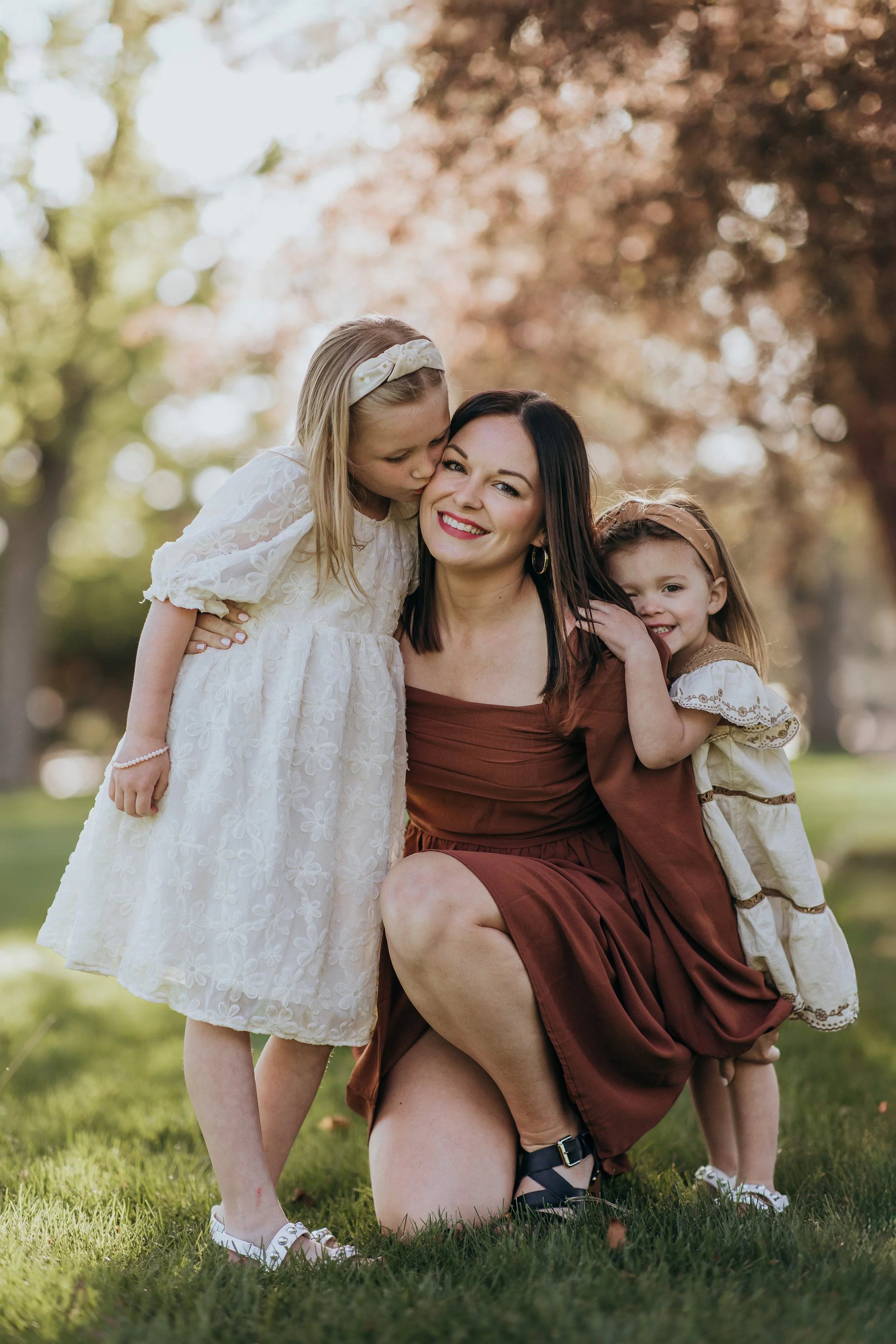 mom playing with kids and smiling during a stress-free family photo session near Kearney, Nebraska