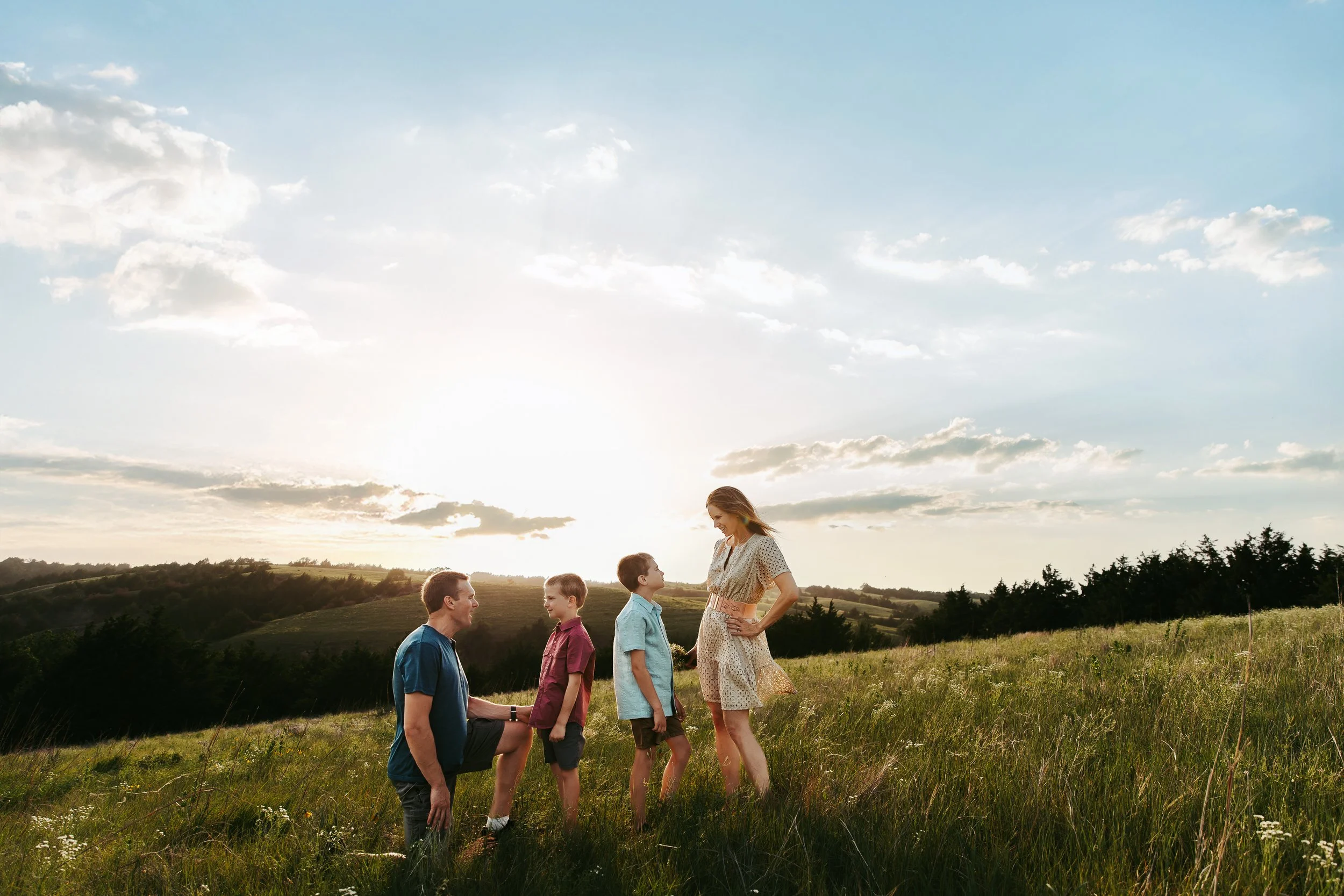 Parents laughing together during a relaxed family photo session in Kearney, Nebraska