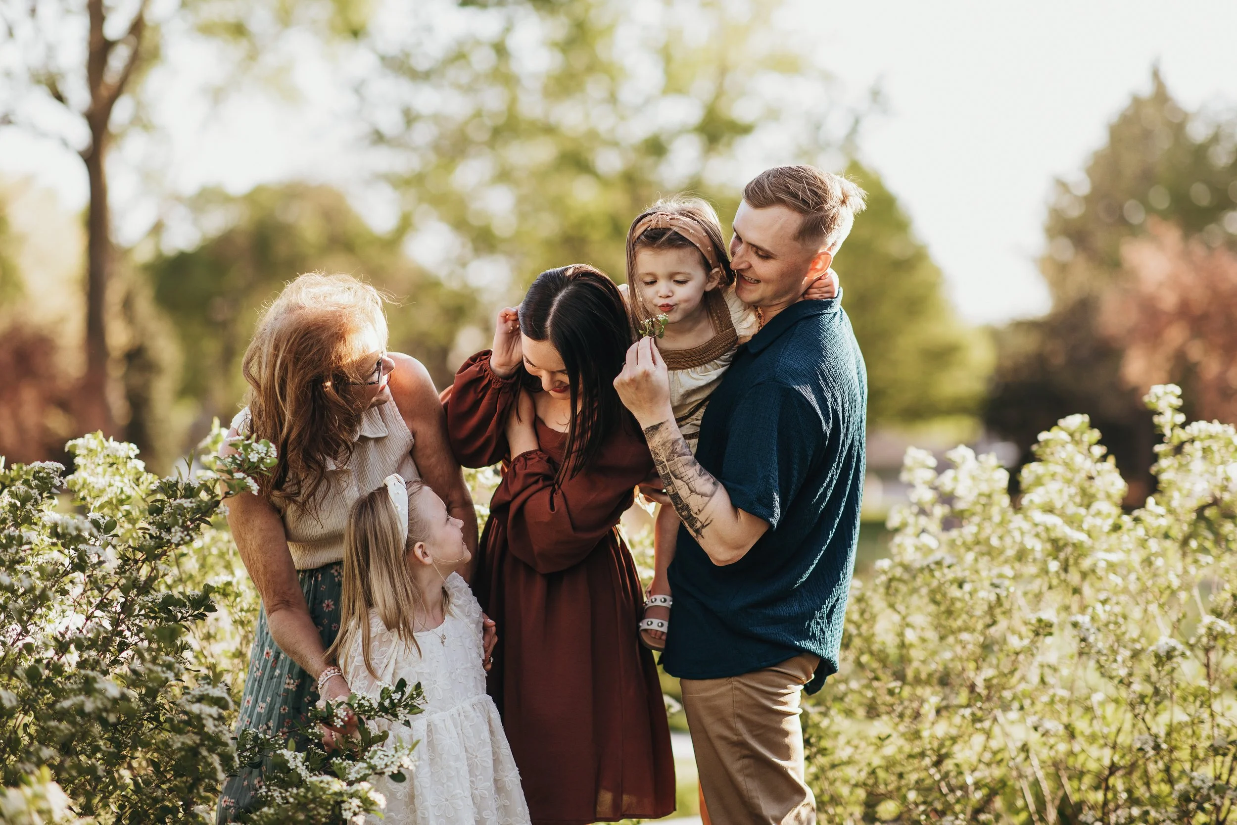 Kids being playful and silly during a relaxed outdoor family photo session in Nebraska