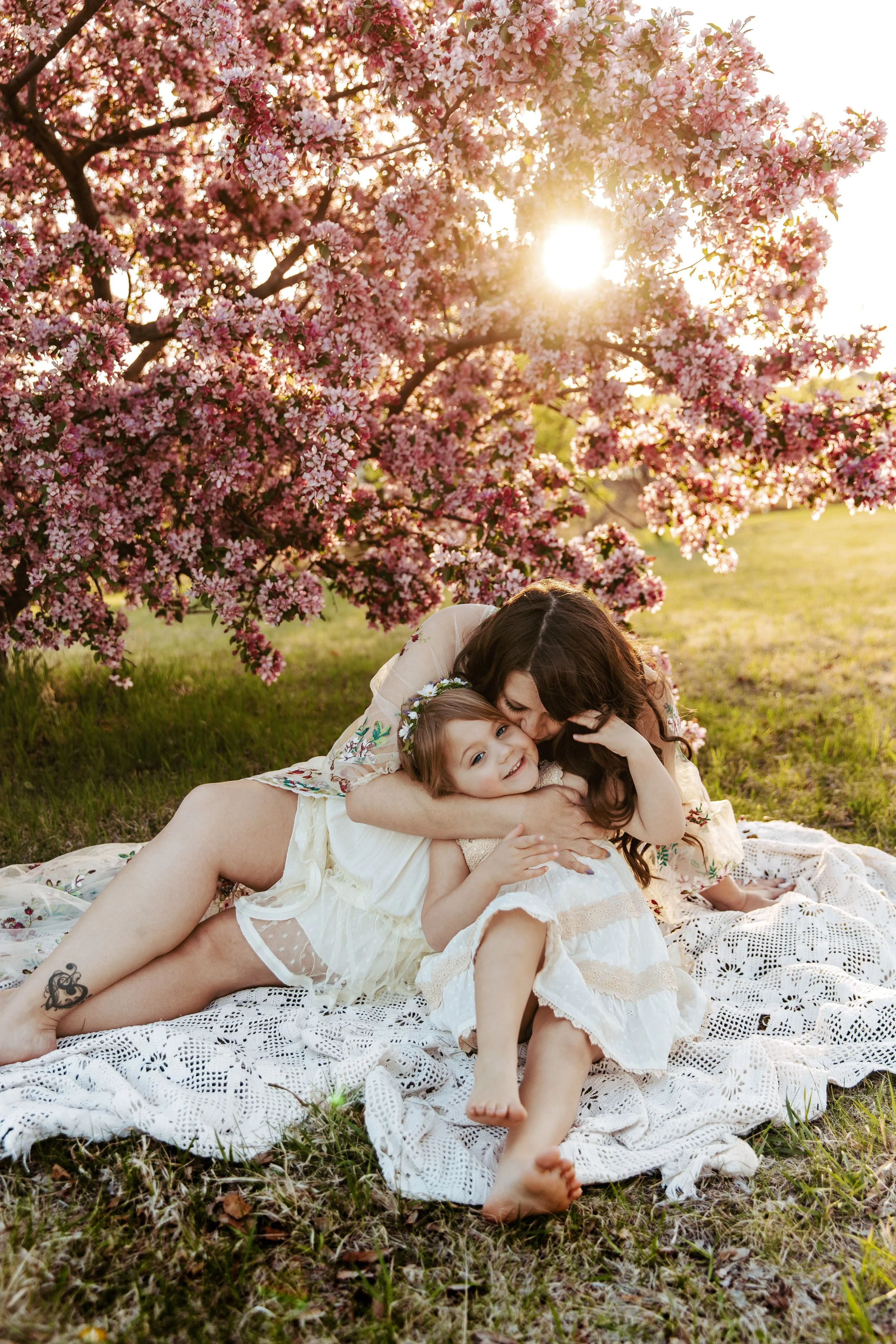 Mom sharing a joyful moment with her children during a family photography session in Kearney, NE