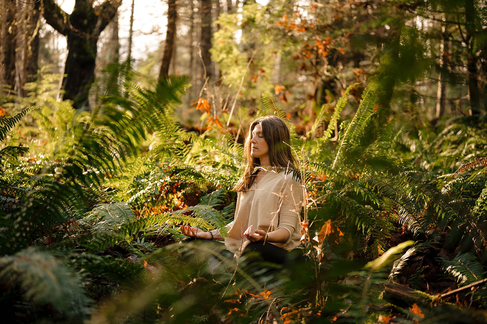Woman-sitting-in-forest-meditating.jpg