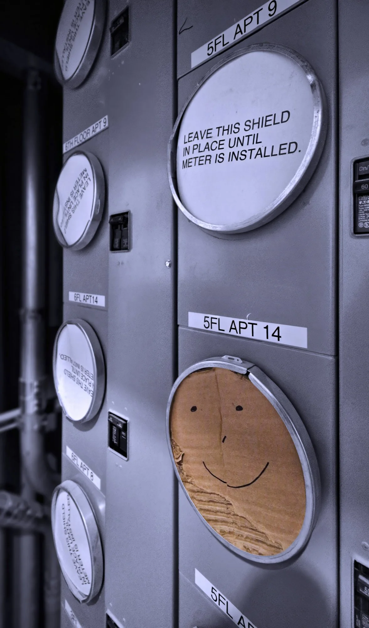 230321.A.03.N.01 - Cardboard Covers on an Electrical Meter Bank Prior to Meter Installation