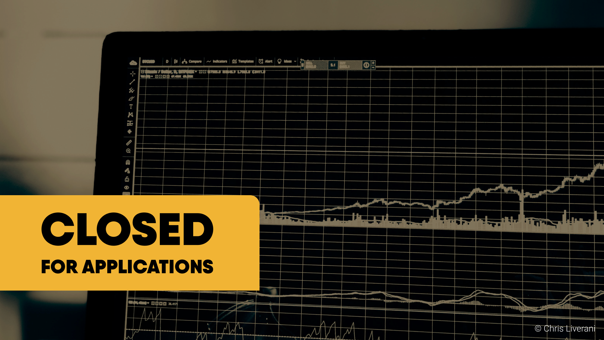 Computer screen displaying a financial chart with stock market data. Overlayed with a yellow box containing the text 'CLOSED FOR APPLICATIONS' in black bold letters.