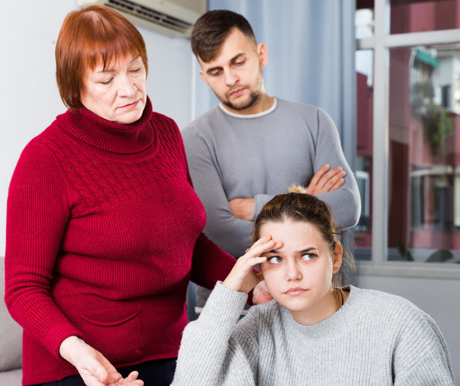 parents hovering over their teenager